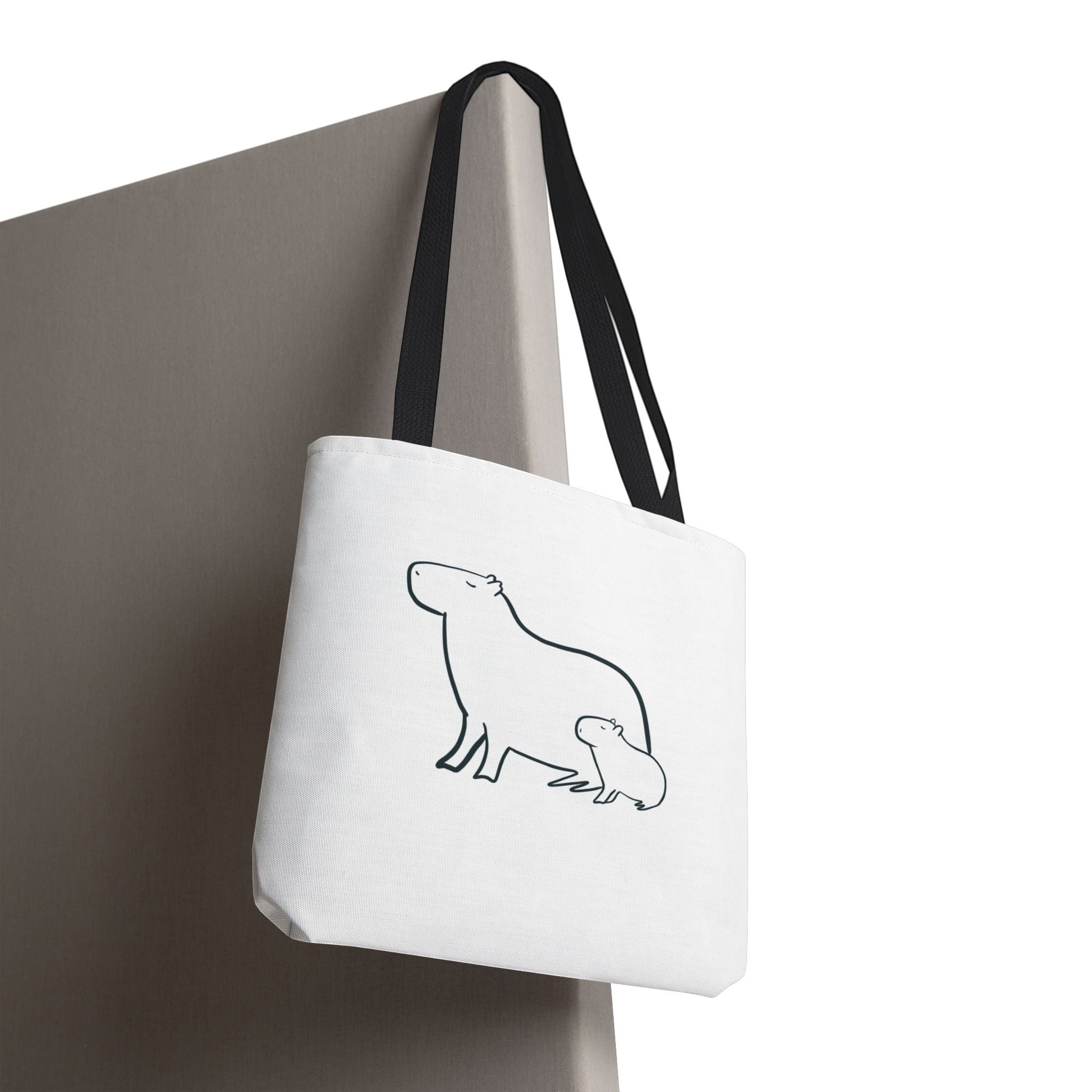 Capy Life minimalist white canvas tote bag featuring a simple black line art illustration of a mother and baby capybara