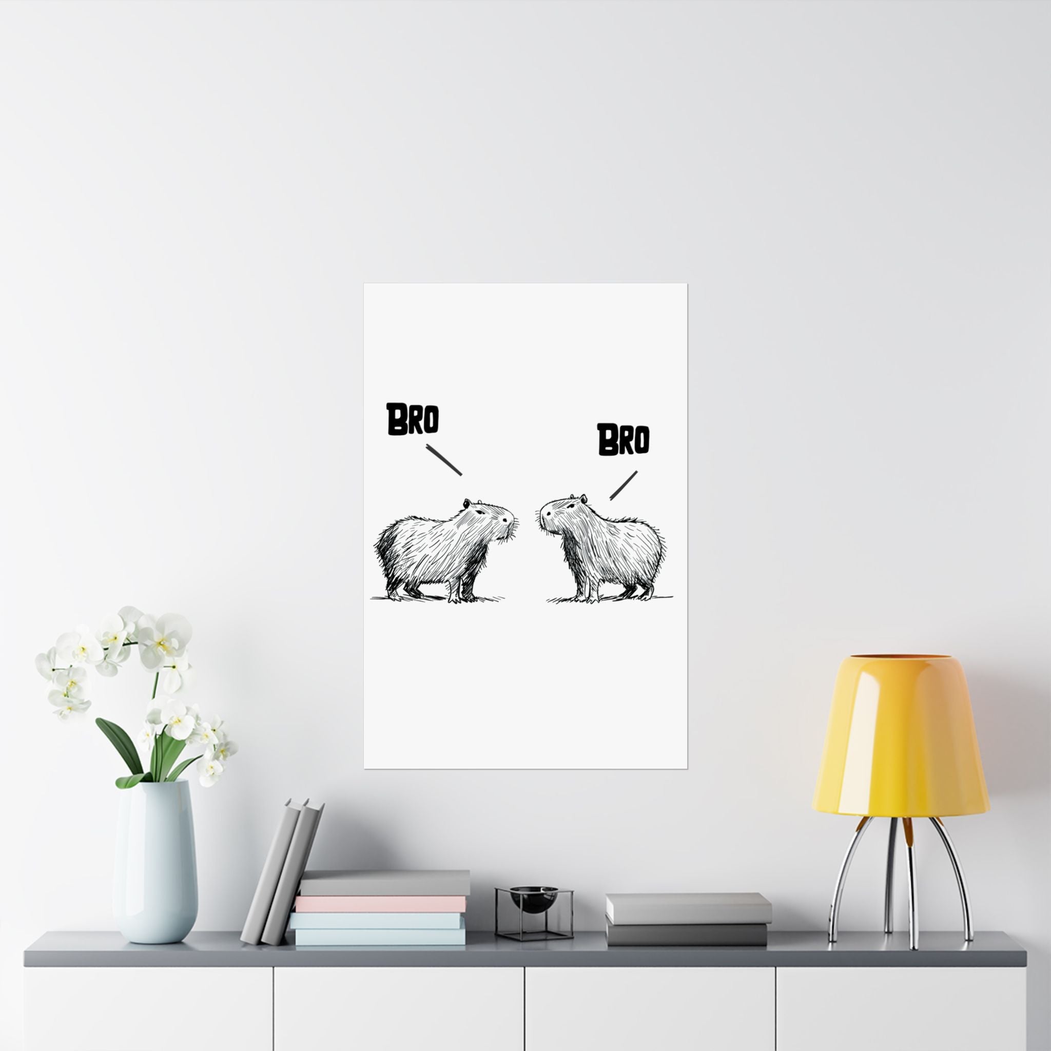Capy Life minimalist wall art print featuring two hand-drawn capybaras facing each other with the text BRO above them.