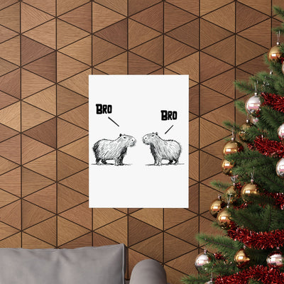 Capy Life minimalist wall art print featuring two hand-drawn capybaras saying BRO, displayed on a wood-paneled wall.