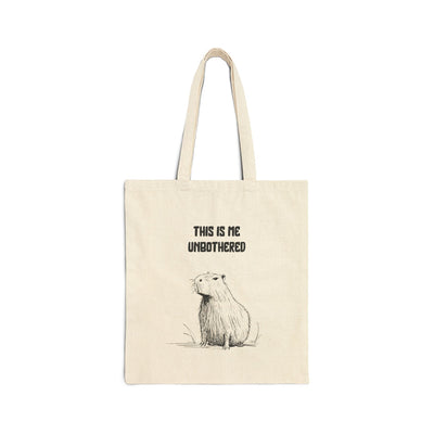Capy Life natural canvas tote bag featuring a minimalist capybara illustration and the text This Is Me Unbothered