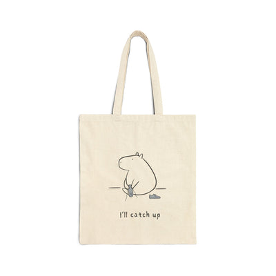Capy Life natural cotton canvas tote bag featuring a minimalist capybara line drawing and the text I’ll catch up.