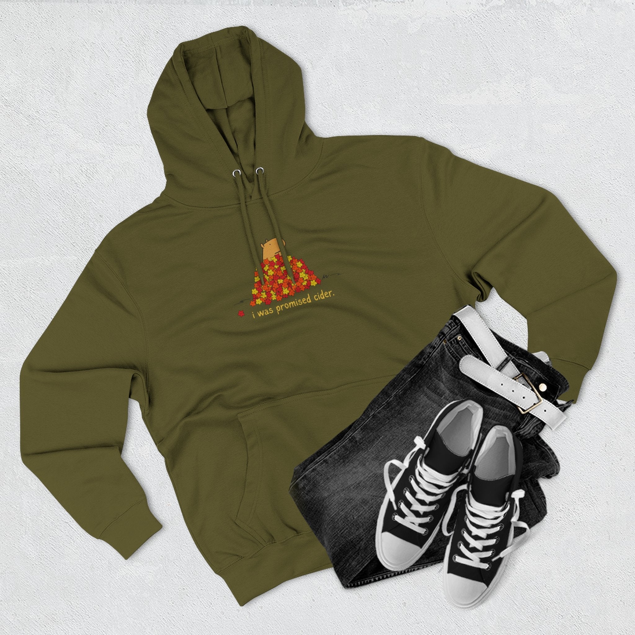 Capy Life olive green fleece hoodie featuring a capybara in autumn leaves with the text I was promised cider