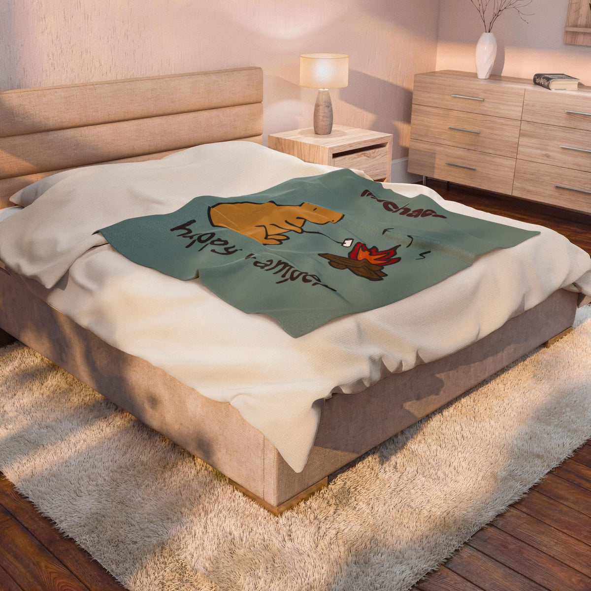 Capy Life personalized sage-green blanket featuring a capybara roasting a marshmallow by a campfire on a bedroom bed.