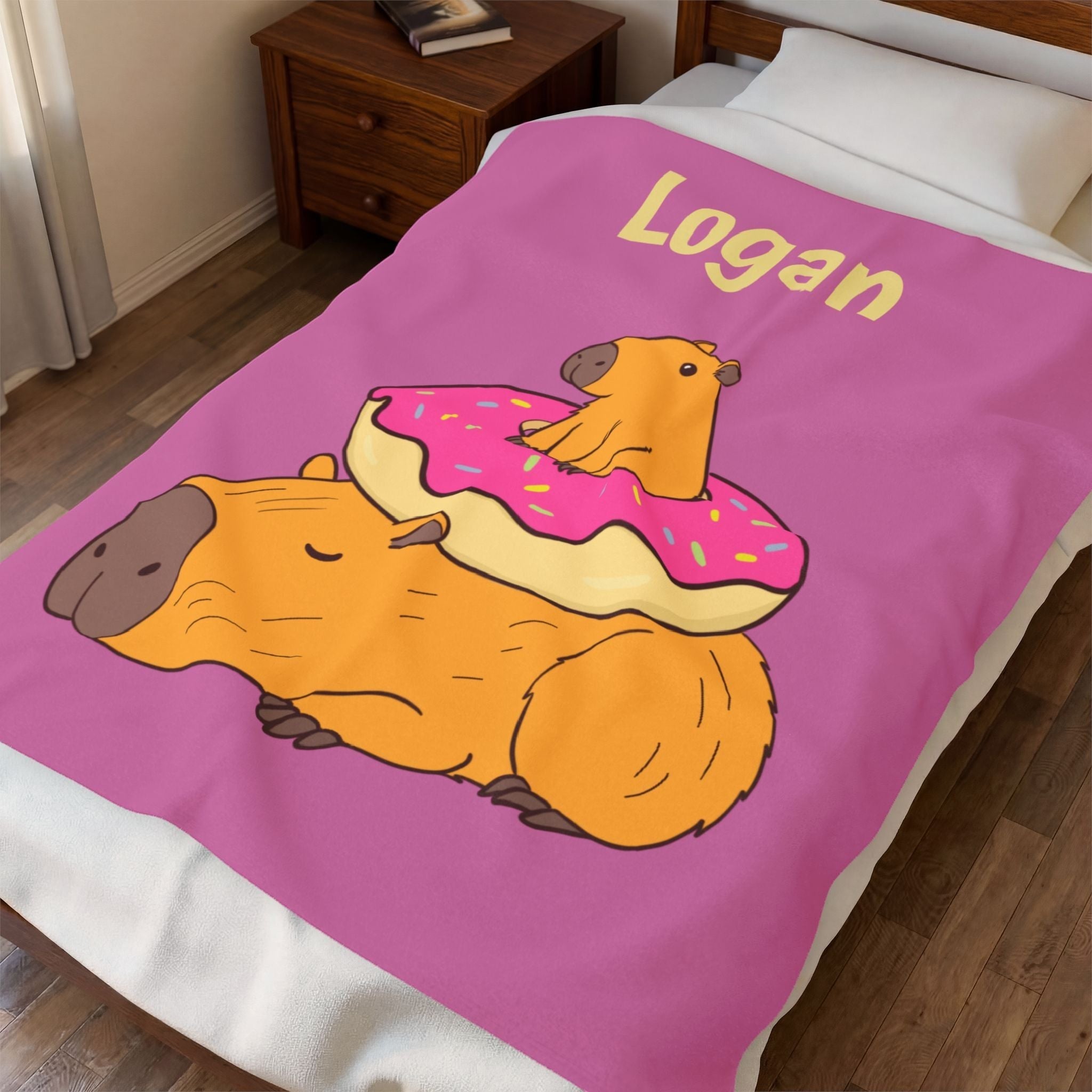Capy Life personalized pink kids blanket featuring a sleeping capybara with a baby capybara on a donut.