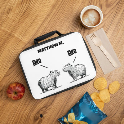 Capy Life personalized kids lunchbox featuring a hand-drawn capybara illustration and custom name on a wooden table.
