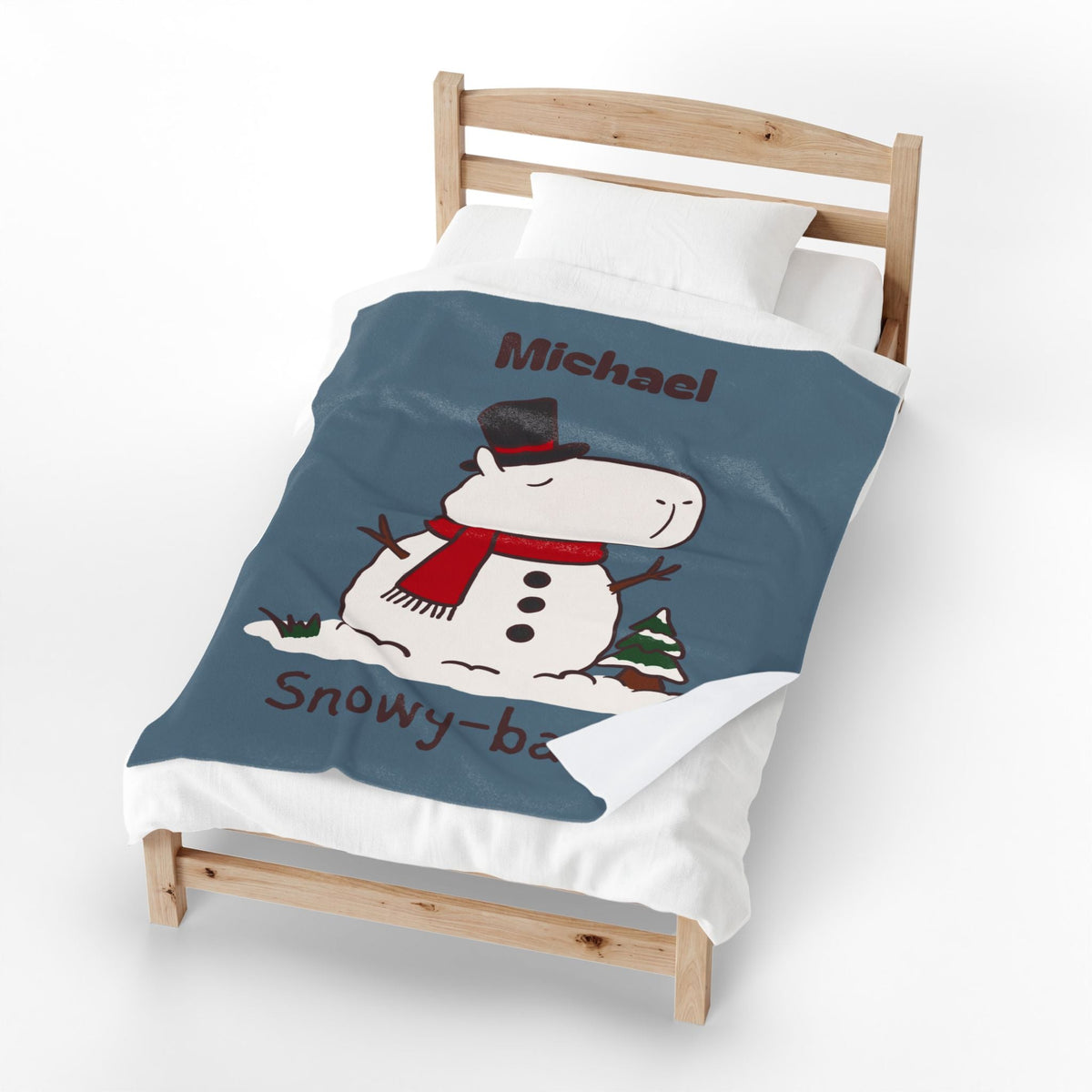 Capy Life personalized dusty blue blanket featuring a capybara snowman with a red scarf and top hat on a wooden bed.