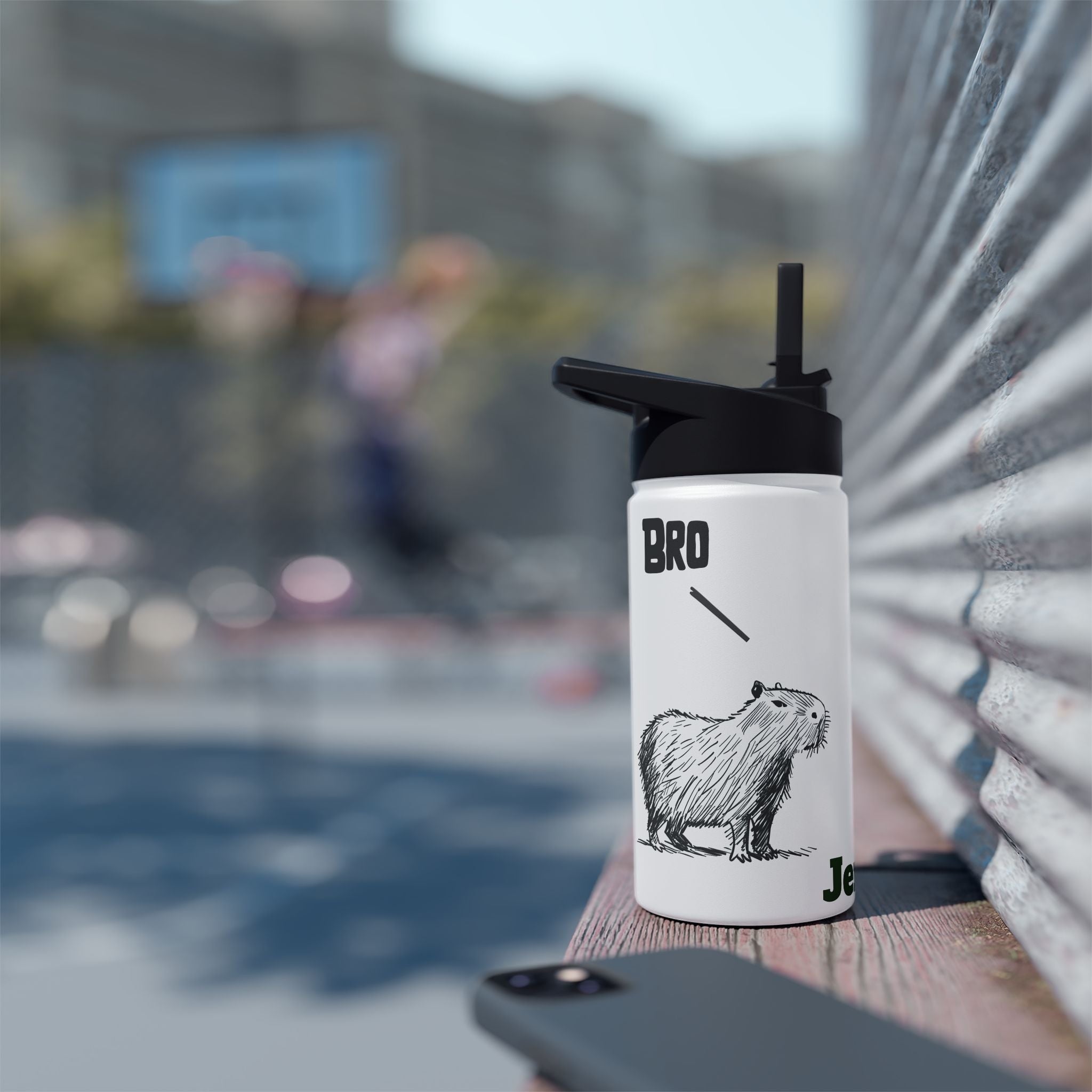 Capy Life personalized white kids water bottle with a hand-drawn capybara illustration and Bro text on a sports court