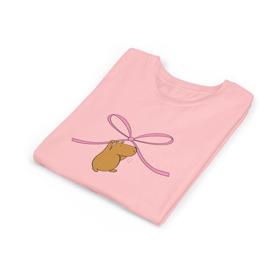 Capy Life pink kids t-shirt featuring a cute capybara hanging from a pink coquette bow graphic