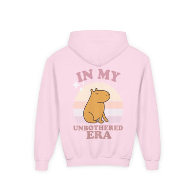 Capy Life pink hoodie featuring a retro sunset graphic with a capybara and the text In My Unbothered Era on the back