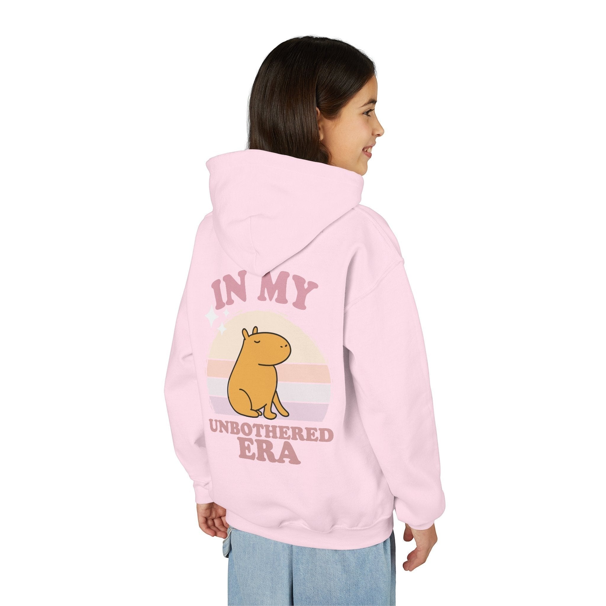 Capy Life pink hoodie featuring a back graphic of a capybara with a retro sunset and In My Unbothered Era text.