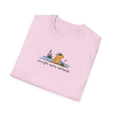 Capy Life light pink softstyle t-shirt featuring a hand-drawn capybara wearing a backwards hat in a wetland scene.