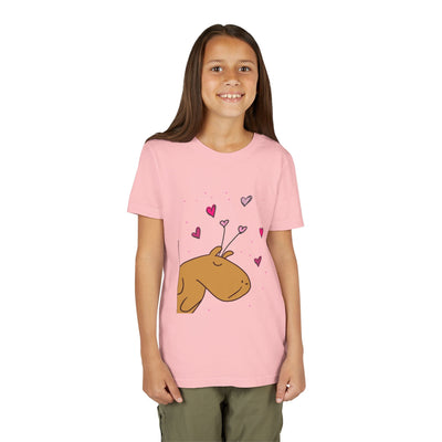 Young girl wearing a Capy Life light pink cotton t-shirt featuring a cute Gene the Capybara Valentine heart graphic.