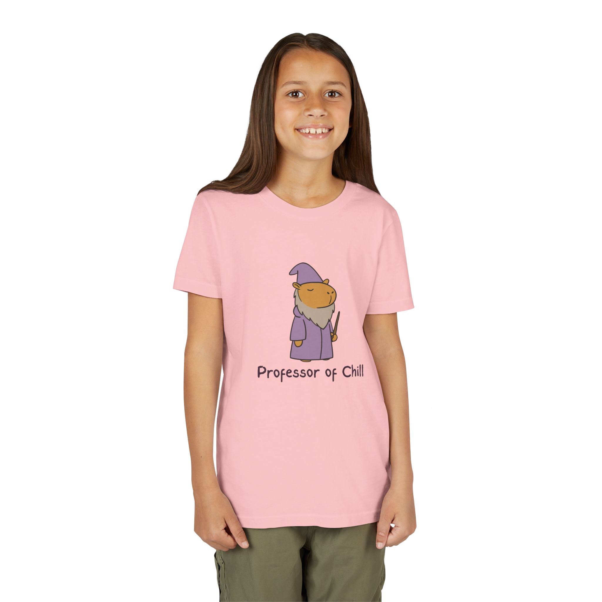 A young girl wearing a Capy Life pink cotton t-shirt featuring a wizard capybara graphic and Professor of Chill text.