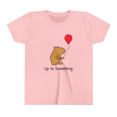 Capy Life pink youth t-shirt featuring a cute capybara holding a red balloon with the text Up to Something.