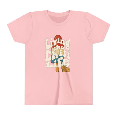 Capy Life youth t-shirt in light pink featuring a retro popsicle graphic with a capybara and groovy text.