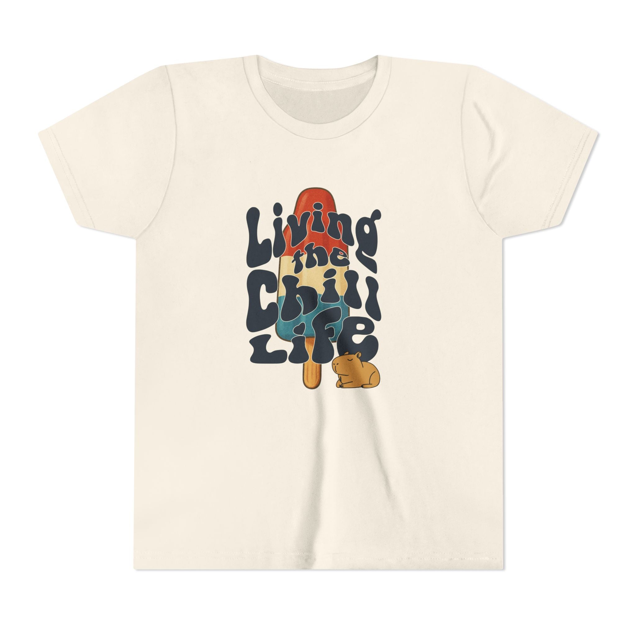Capy Life youth t-shirt in cream cotton featuring a retro popsicle graphic and a cute capybara with groovy text.