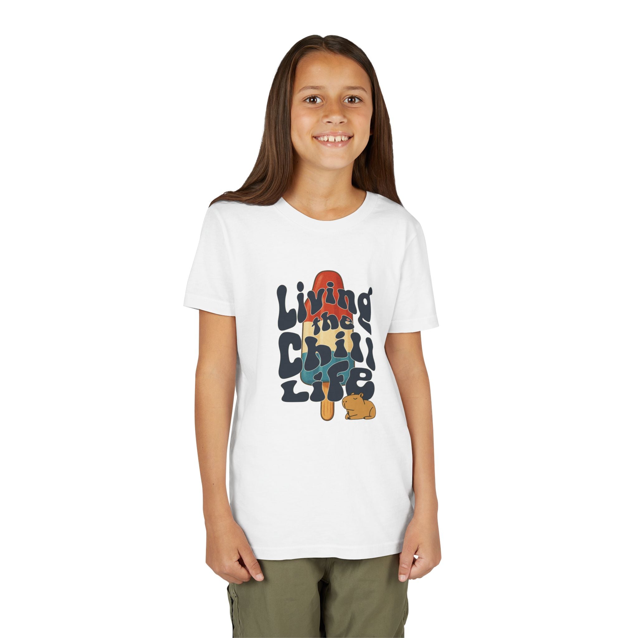 A young girl wearing a white Capy Life youth t-shirt with a retro popsicle and capybara graphic print.