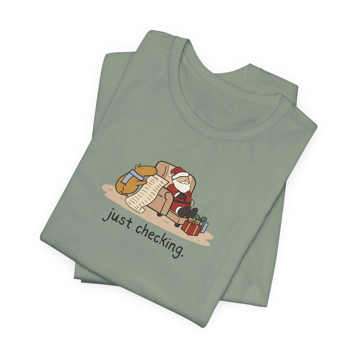 Capy Life sage green t-shirt featuring a hand-drawn illustration of a capybara checking Santa's naughty or nice list.