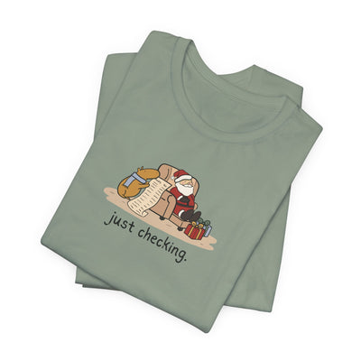 Capy Life sage green t-shirt featuring a hand-drawn illustration of a capybara checking Santa's naughty or nice list.