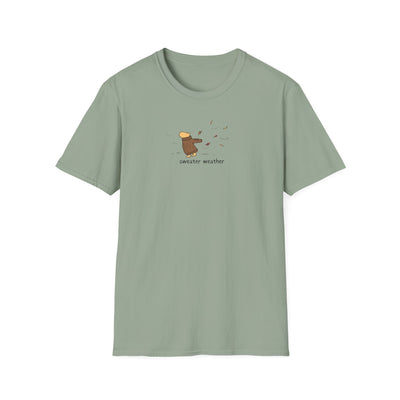 Capy Life softstyle t-shirt in sage green featuring a small graphic of a capybara in a brown sweater in autumn wind.