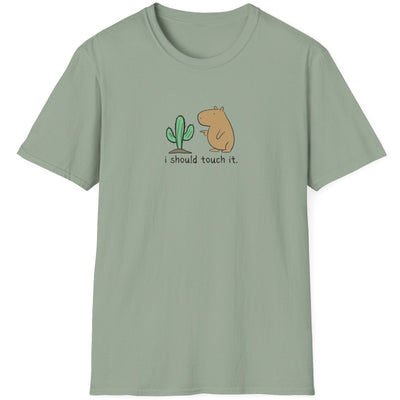 Capy Life softstyle t-shirt in sage green featuring a hand-drawn capybara contemplating touching a cactus.