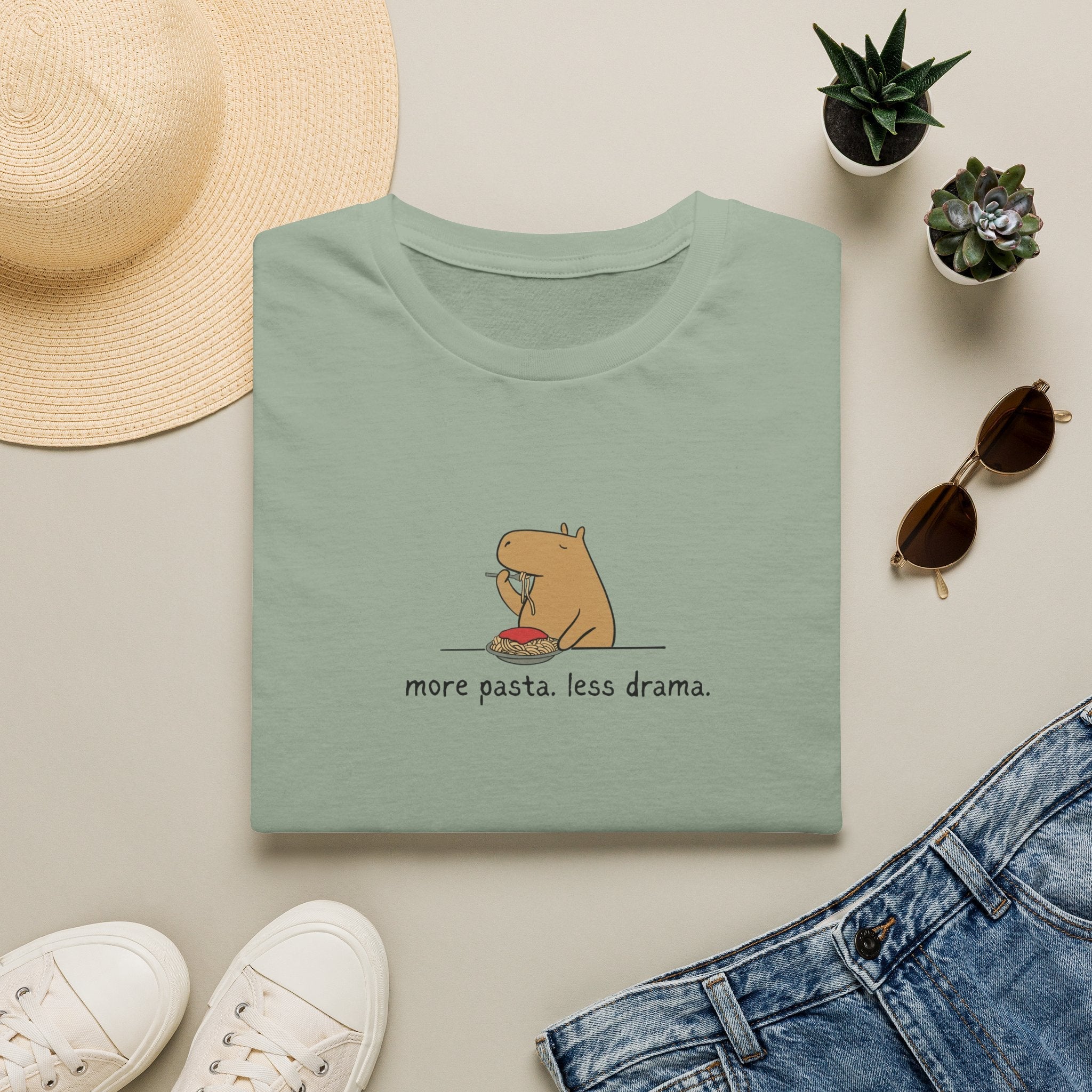 Capy Life sage green softstyle t-shirt featuring a minimalist capybara eating spaghetti with the text more pasta less drama