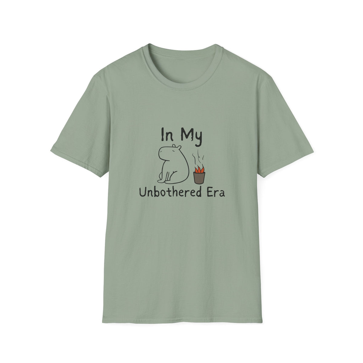 Capy Life sage green softstyle t-shirt featuring a hand-drawn calm capybara sitting next to a small fire.