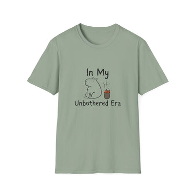 Capy Life sage green softstyle t-shirt featuring a hand-drawn calm capybara sitting next to a small fire.