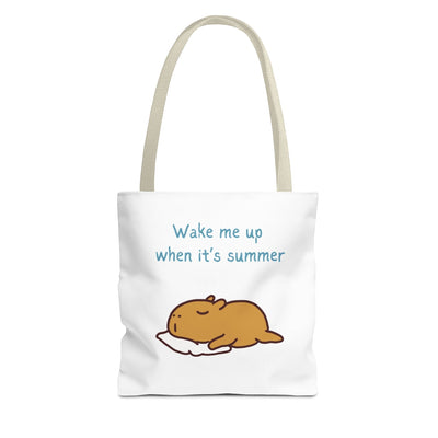 Capy Life white canvas tote bag featuring a cute illustration of a sleeping capybara and the text Wake me up when it's summer.