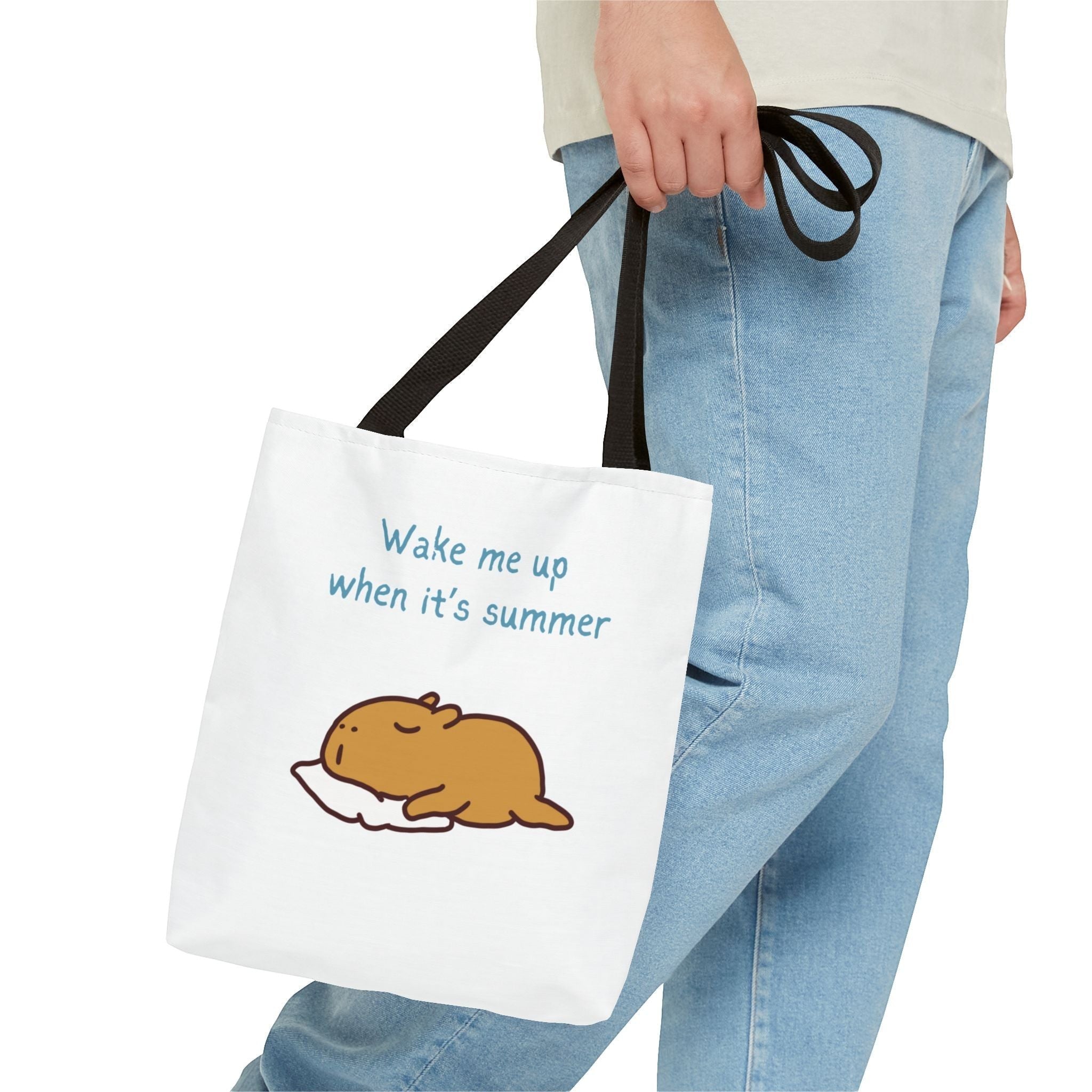 Capy Life white canvas tote bag featuring a sleepy capybara illustration and the text Wake me up when it's summer.