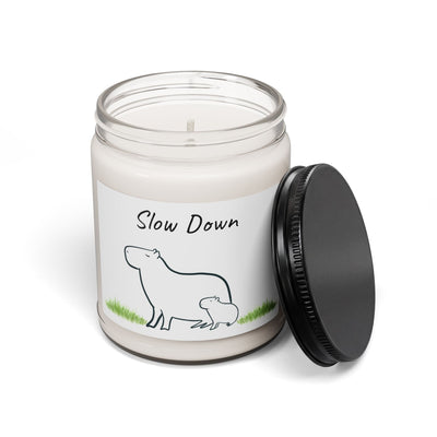 Capy Life soy wax candle in a glass jar with a minimalist illustration of a mother and baby capybara on the label.