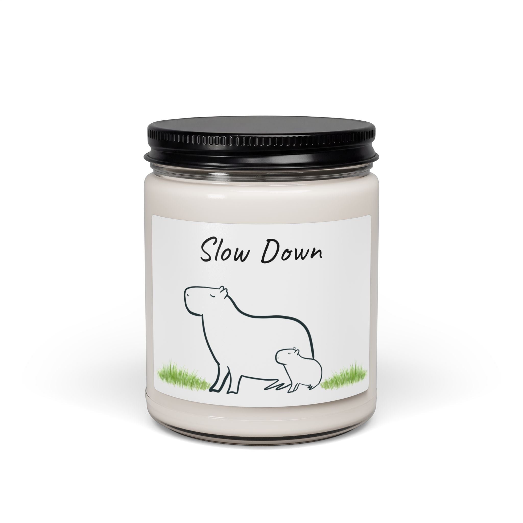 Capy Life Slow Down cinnamon vanilla soy wax candle in a reusable glass jar with a minimalist mother and baby capybara illustration.