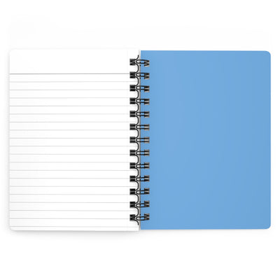 Capy Life spiral notebook open to a lined page with a solid blue back cover