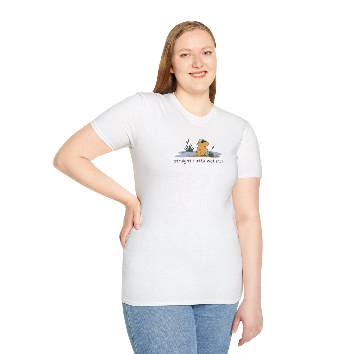 Capy Life white softstyle t-shirt featuring a small hand-drawn capybara wearing a backwards hat in a wetland scene.