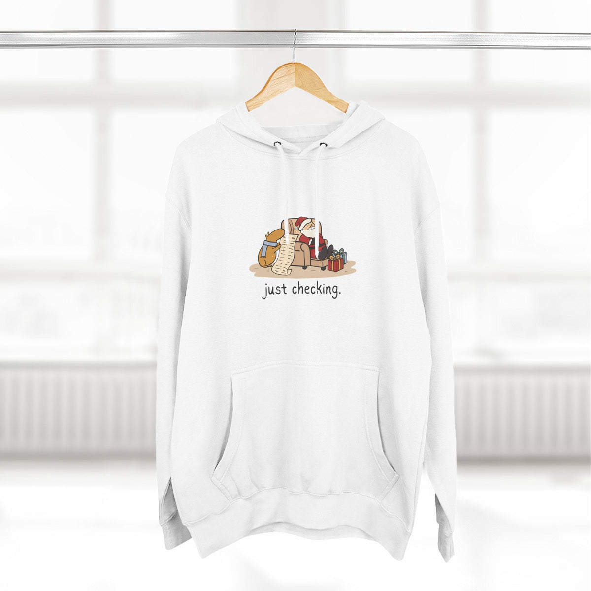 Capy Life white fleece hoodie featuring a hand-drawn capybara checking Santa's naughty-or-nice list.