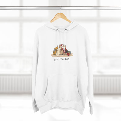 Capy Life white fleece hoodie featuring a hand-drawn capybara checking Santa's naughty-or-nice list.