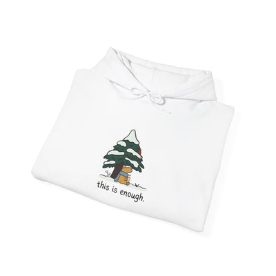 Capy Life white pullover hoodie featuring a hand-drawn capybara in a blue scarf under a snowy evergreen tree.