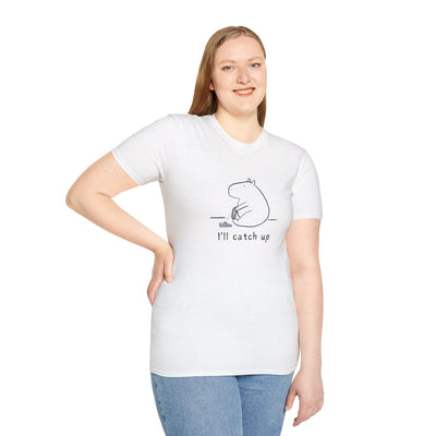 Woman wearing a white Capy Life softstyle t-shirt with a minimalist capybara graphic and the text I'll catch up