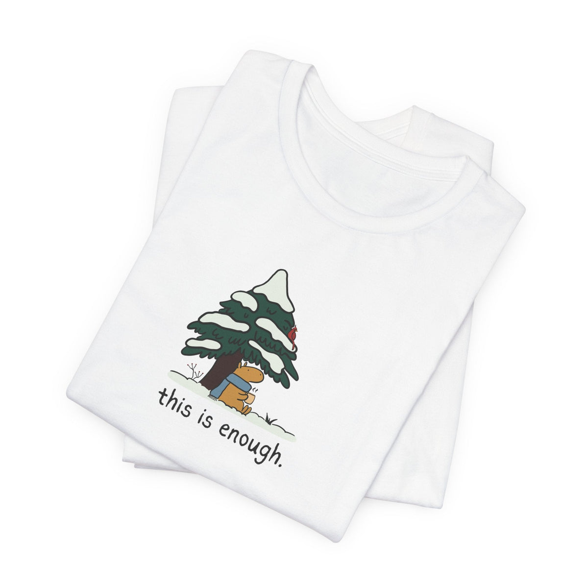 Capy Life white graphic t-shirt featuring a capybara in a blue scarf under a snowy evergreen tree with text.