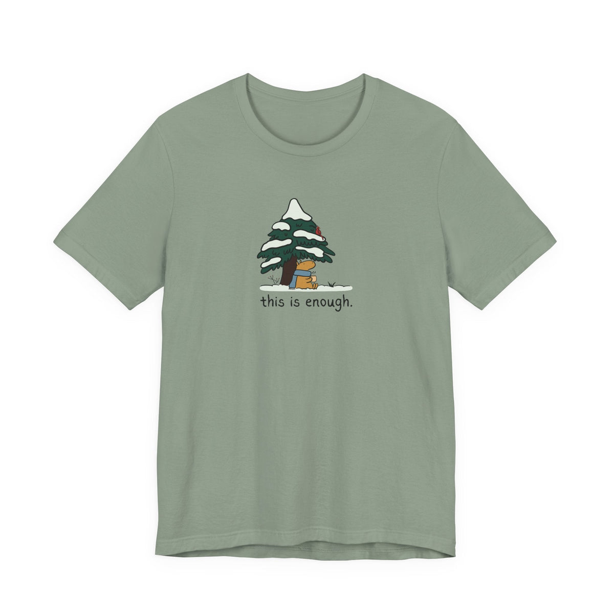 Capy Life sage green t-shirt featuring a cute capybara in a blue scarf under a snowy evergreen tree with text.
