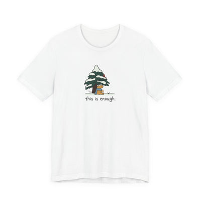 Capy Life white graphic t-shirt featuring a capybara in a blue scarf under a snowy evergreen tree with text.