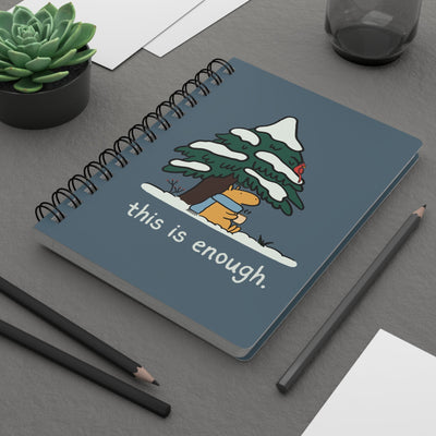 Capy Life spiral notebook with a blue cover featuring a capybara in a scarf under a snowy tree and winter text.