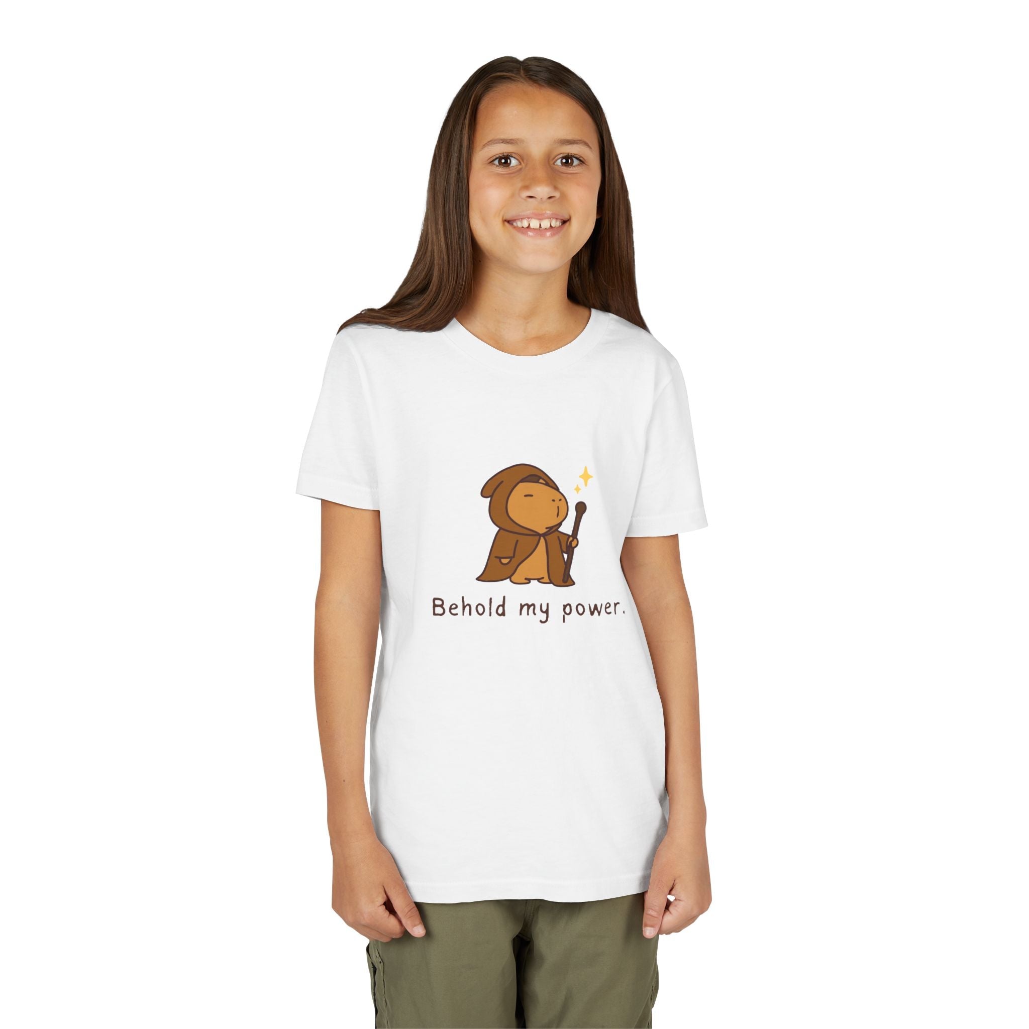 A young girl wearing a white Capy Life kids t-shirt featuring a cute capybara wizard illustration and text.